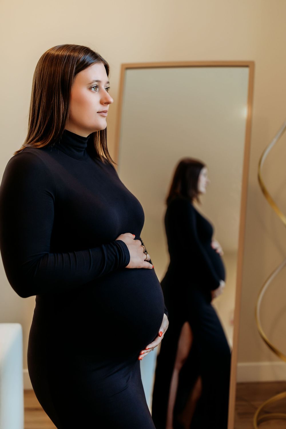 A person in a black turtleneck sweater stands against a beige wall in a series of connected profile shots.