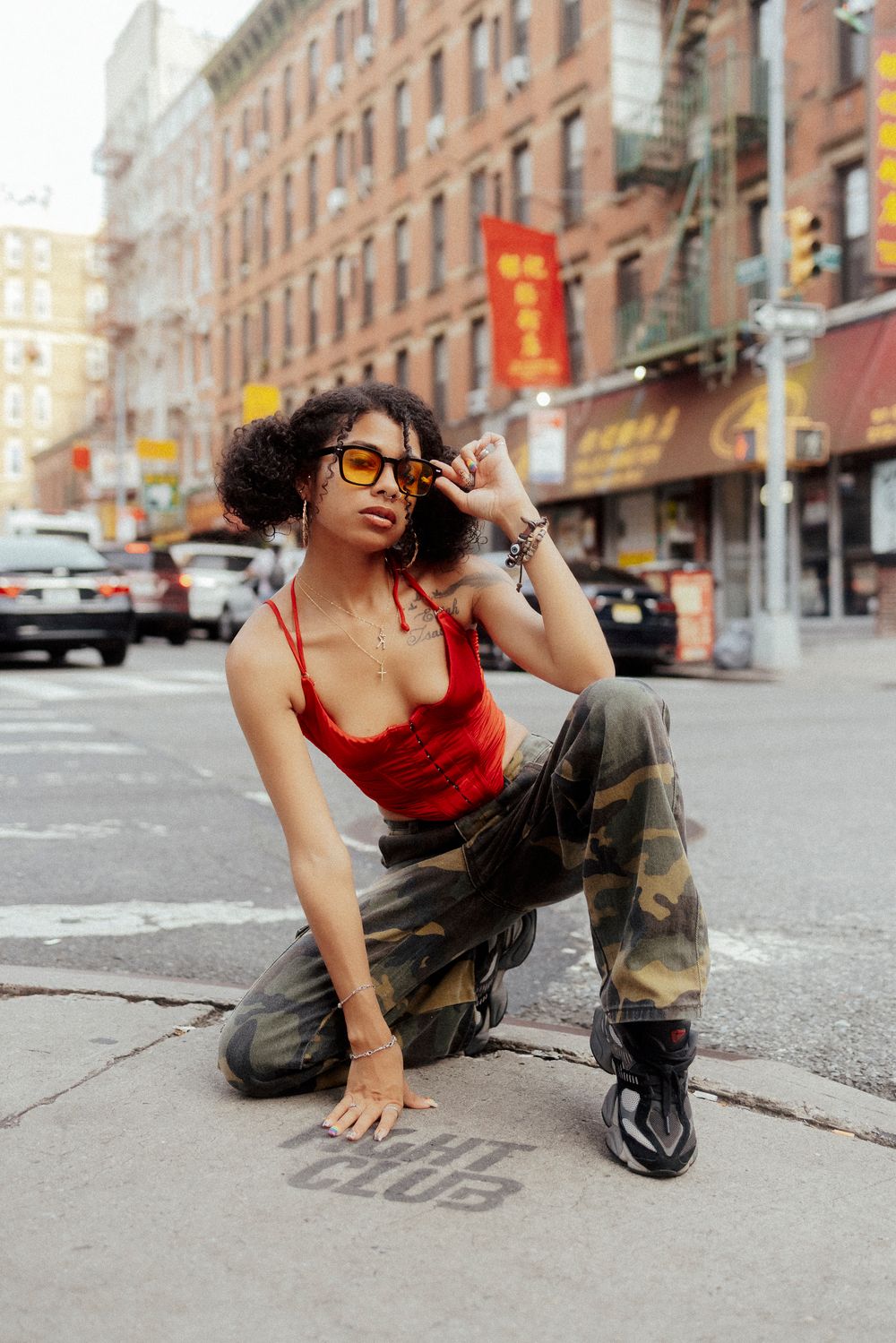 Urban street fashion photo series showing dynamic poses against a city sidewalk background in New York City.