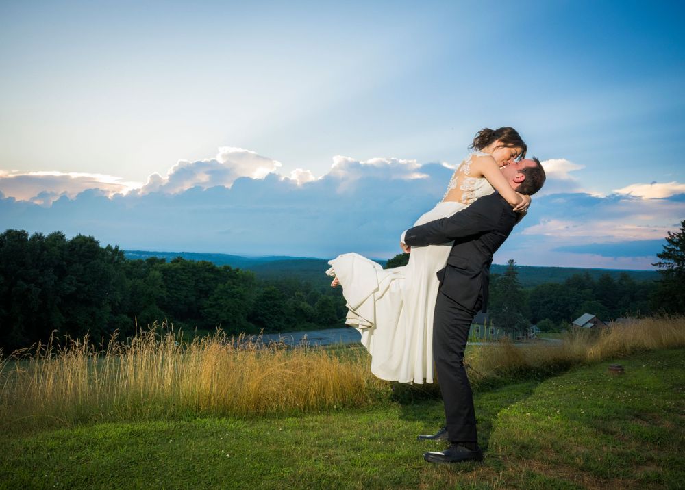 Romantic lift pose against mountain vista during golden hour.