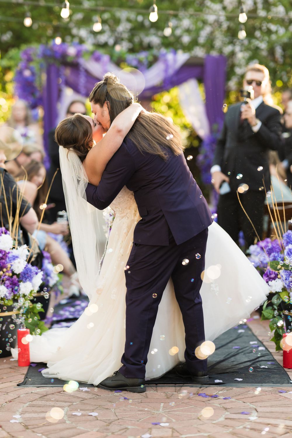 Bride and groom exchange vows during an outdoor wedding ceremony, captured by Chris Cornish Photography.