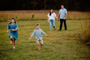 A playful sequence of children running and playing in a grassy field during golden hour.