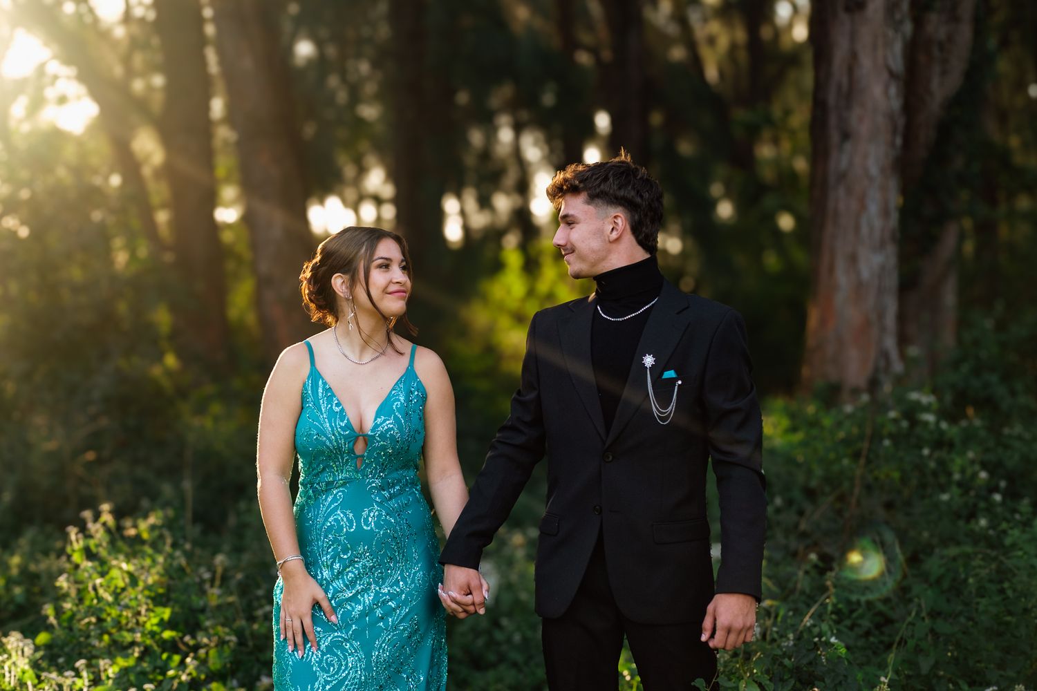 Matriculants laughing together in a forest during a farewell photoshoot