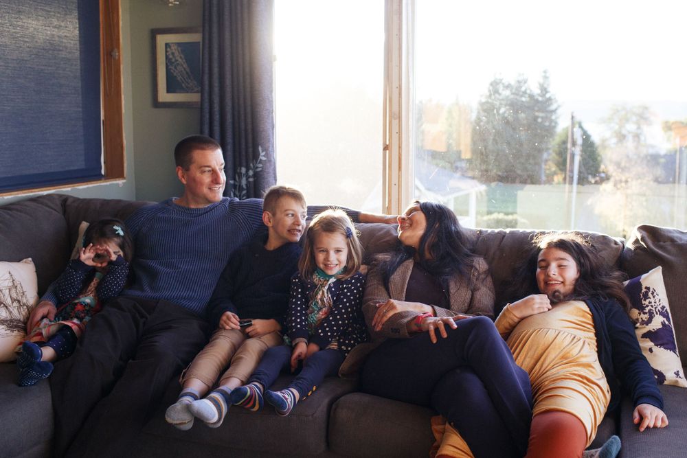 Seattle family photographer: a mother and father with their 4 kids at an in-home family photo session in Mukilteo