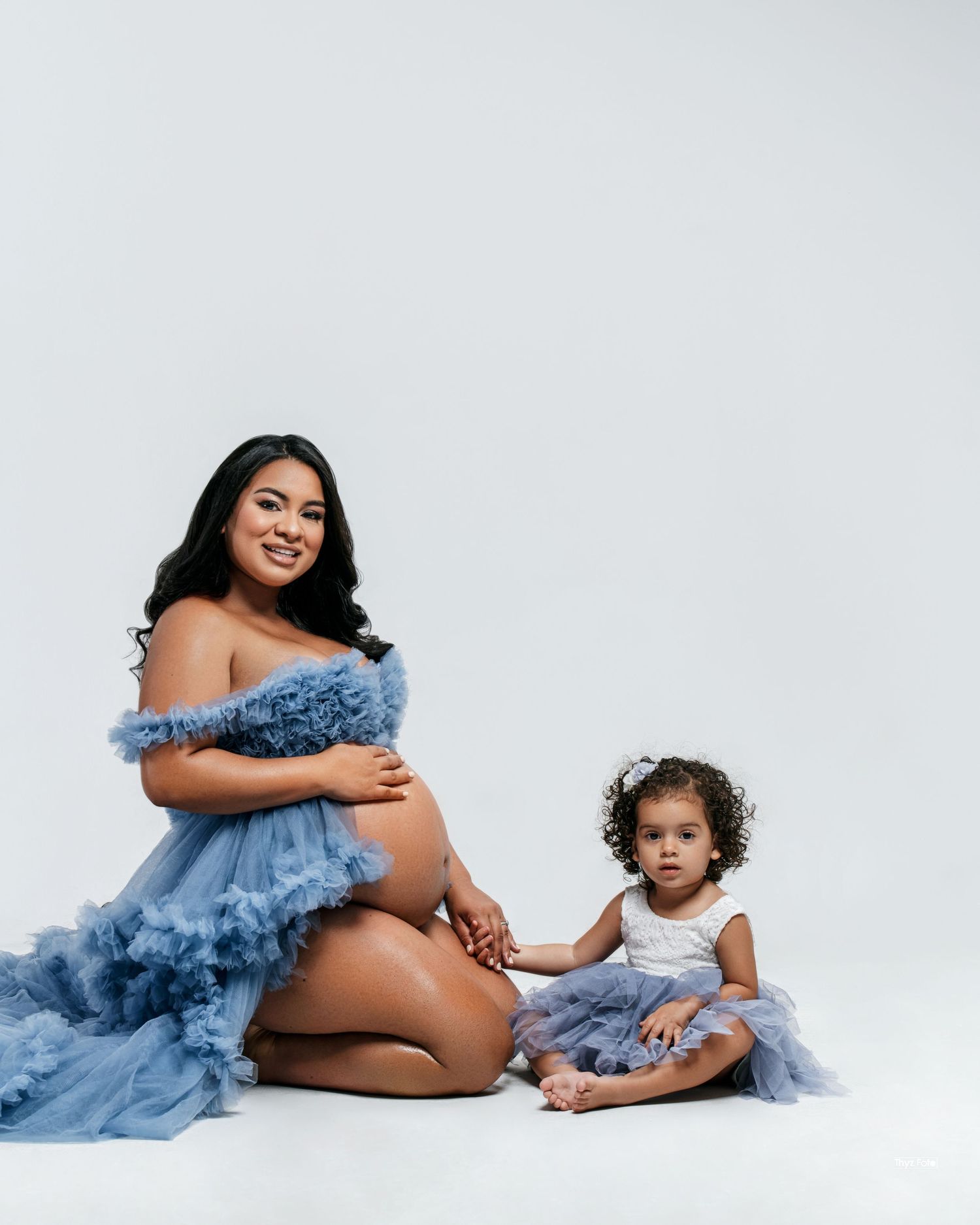 Family maternity session with an expecting mother and her child, capturing warmth and connection.