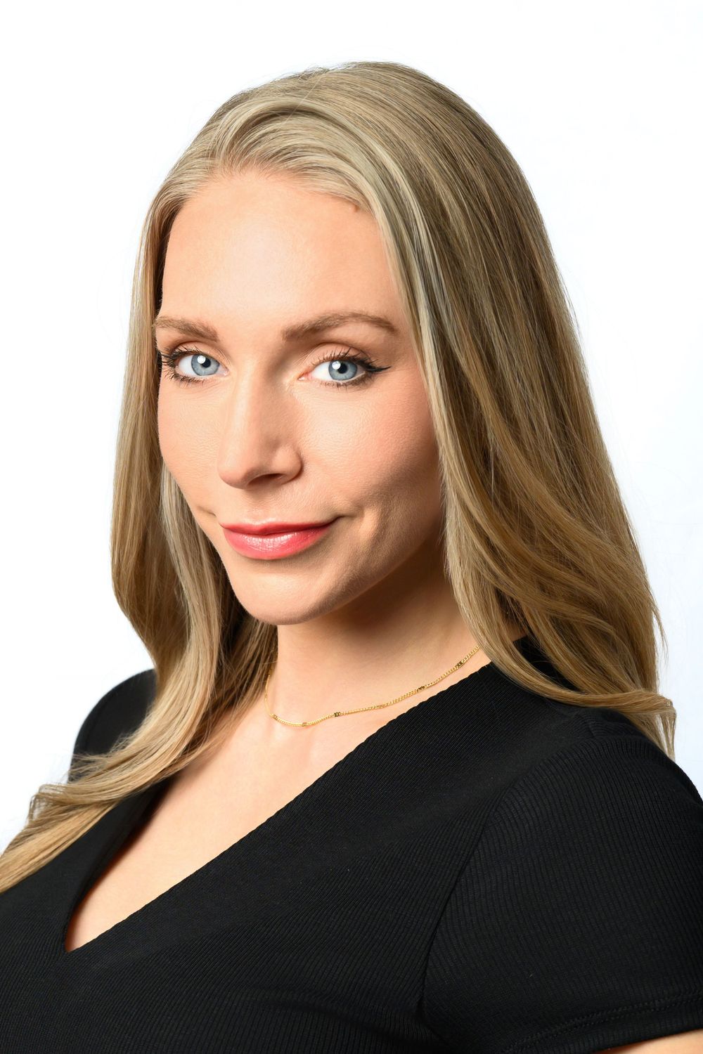 Professional headshot portrait with long blonde hair wearing a black v-neck top against white background.