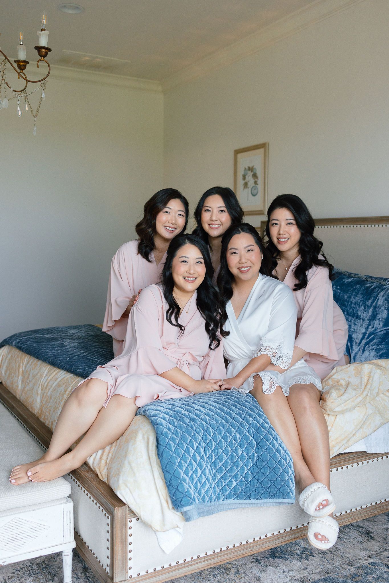 Bride with her bridesmaids with stunning natural glam makeup by Gaby Makeup Artistry, on a sunny day in Oklahoma City, with their bouquets