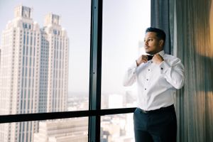 Professional formal portraits in a modern high-rise building with city views.