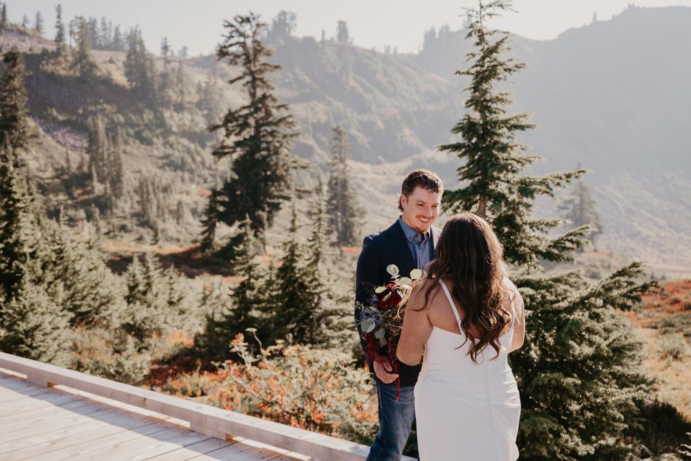 A couple embraces while enjoying scenic mountain views on a misty autumn day in the Pacific Northwest.