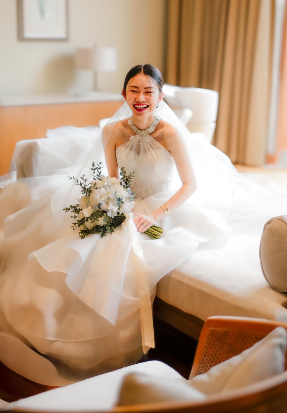 Indoor wedding shoot of the bride preparing for their actual day ceremony, captured by a wedding photographer in Singapore