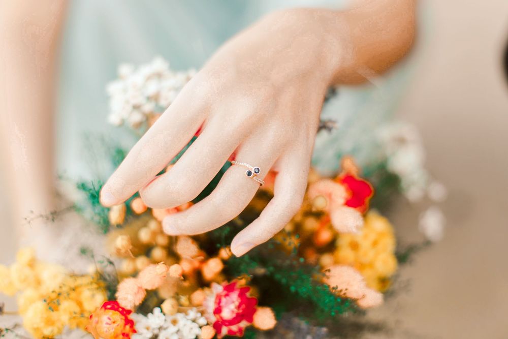 Engagement prewedding shoot of a couple during an outdoor, nature photoshoot in Singapore, showing the engagement ring on the hand
