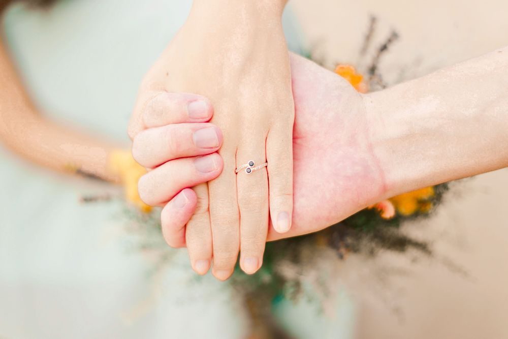 Engagement prewedding shoot of a couple during an outdoor, nature photoshoot in Singapore, showing the engagement ring on the hand