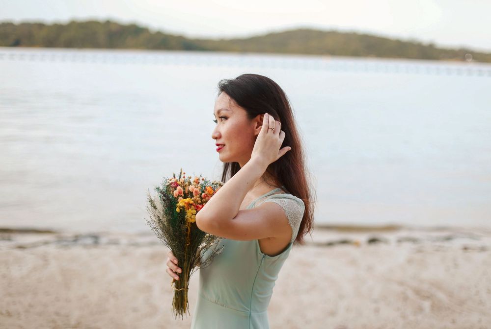 Engagement prewedding shoot of a couple during an outdoor, nature photoshoot in Singapore, showing the engagement ring on the hand