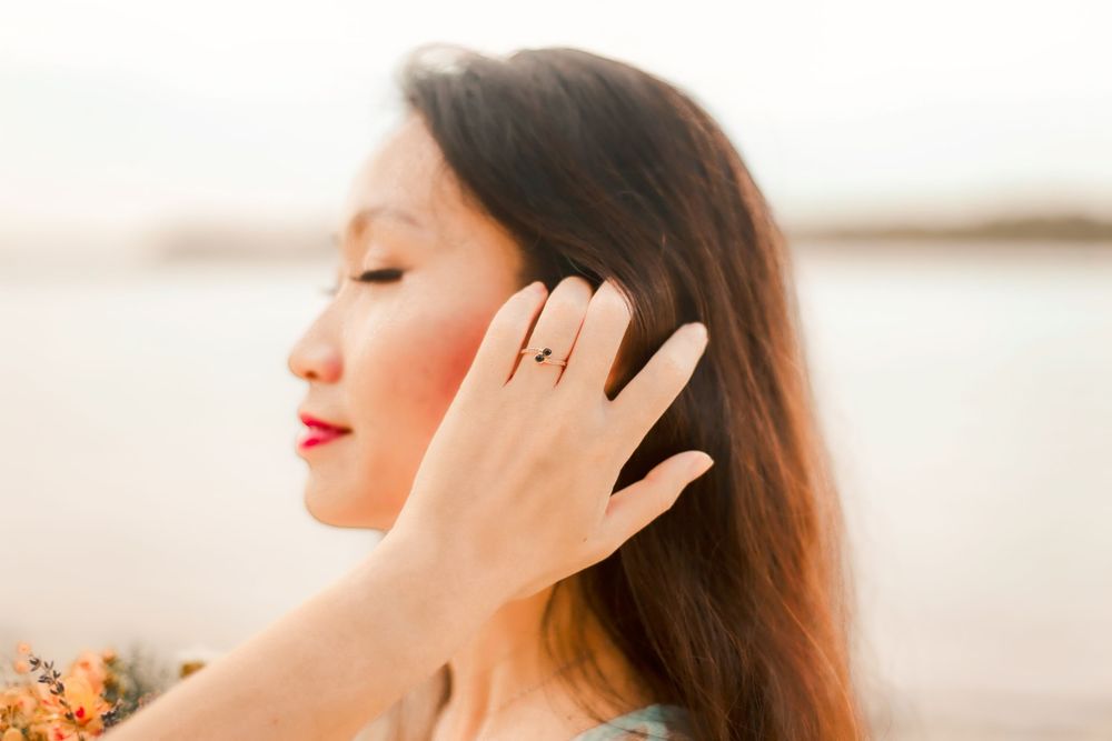 Engagement prewedding shoot of a couple during an outdoor, nature photoshoot in Singapore, showing the engagement ring on the hand