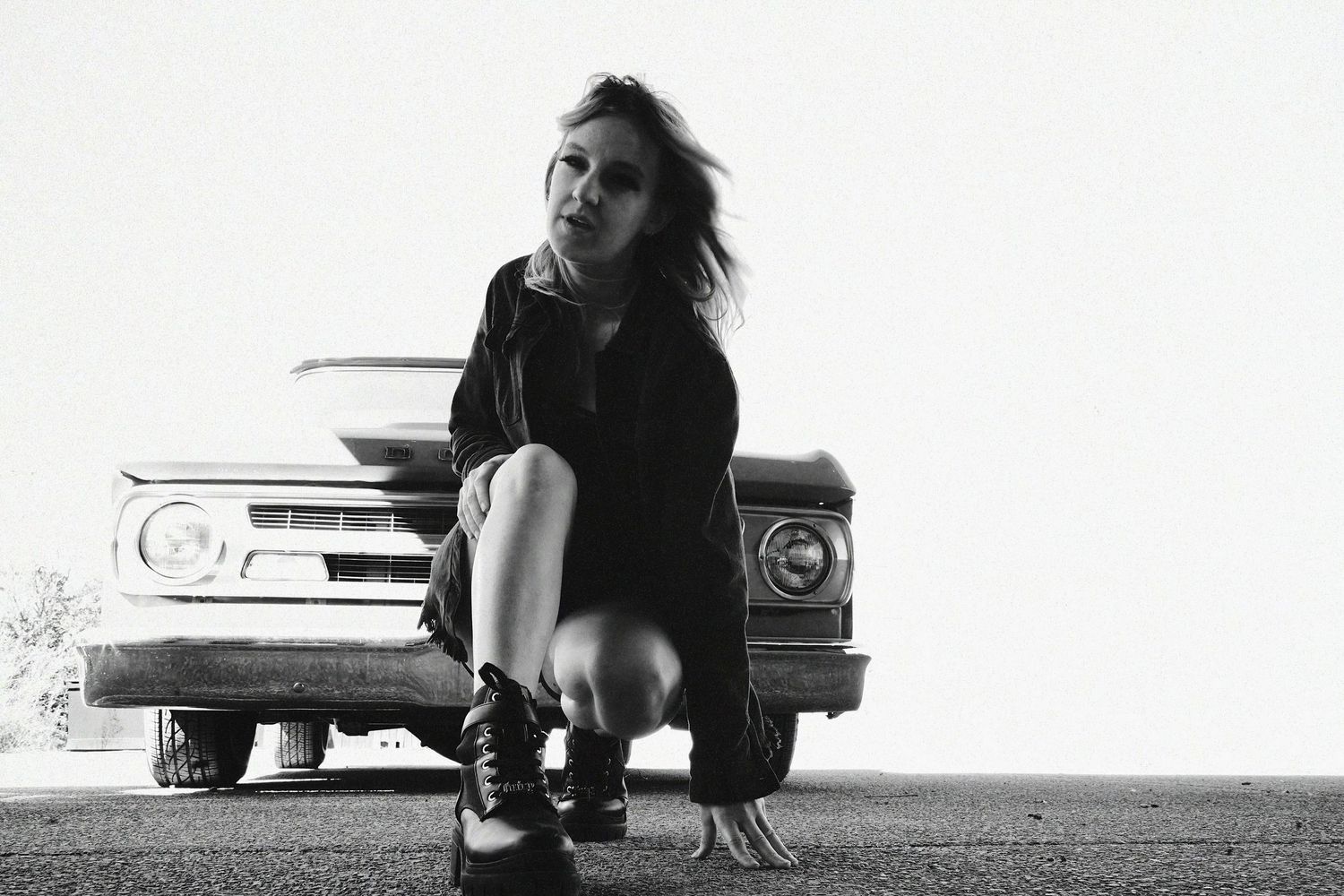 Artistic black and white photo composition with vintage car silhouette.