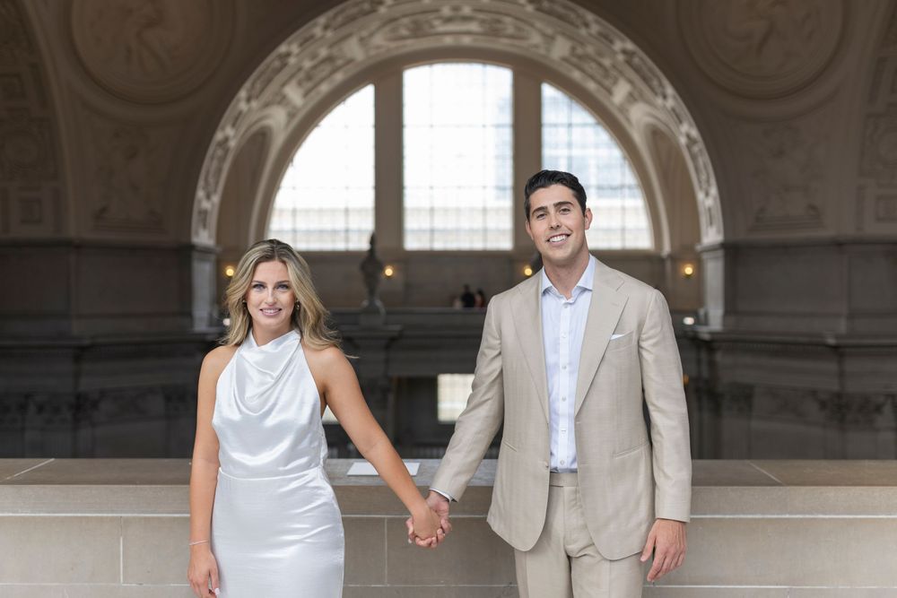 Couple standing together in natural light portrait at San Francisco City Hall on the 4th floor