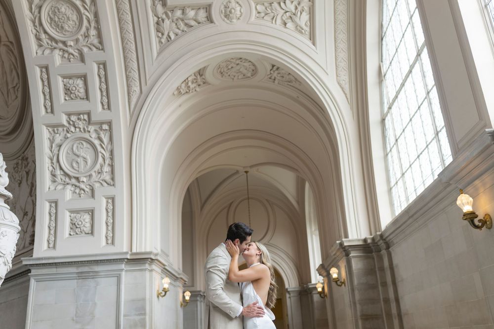 Couple embracing in natural light portrait at San Francisco City Hall's 4th floor