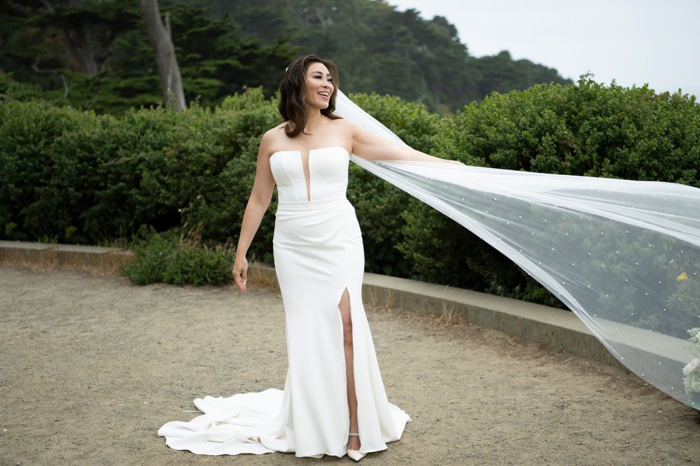 Bride's veil blowing in the breeze at Lands End in San Francisco