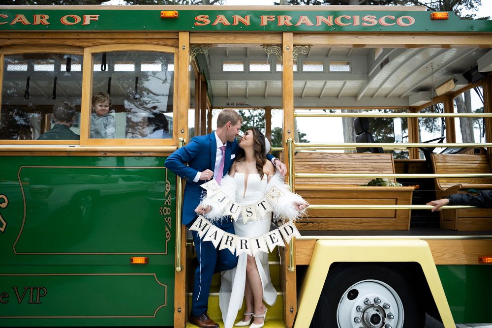 Bride and groom on a cable car in San Francisco