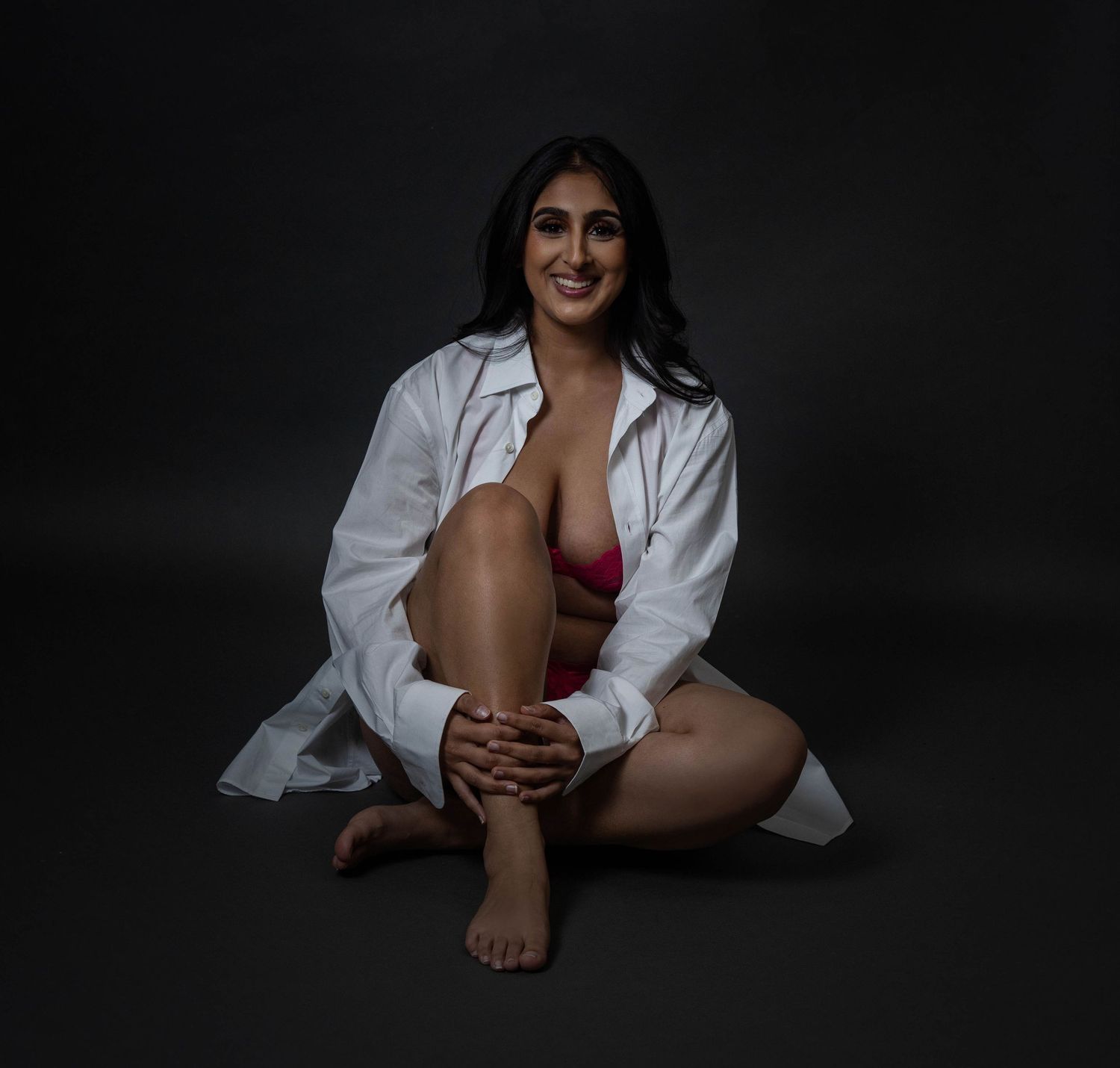 Confident woman in boyfriend's shirt during a boudoir session in Woodstock GA