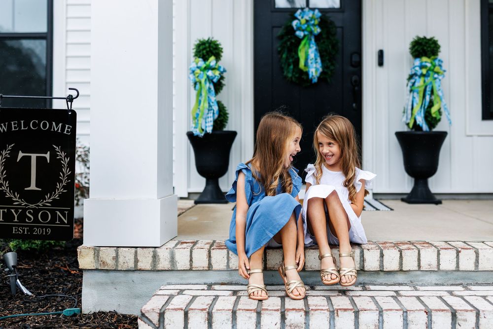 A series of lifestyle photos showing people sitting and relaxing on white porch steps in a modern farmhouse setting.
