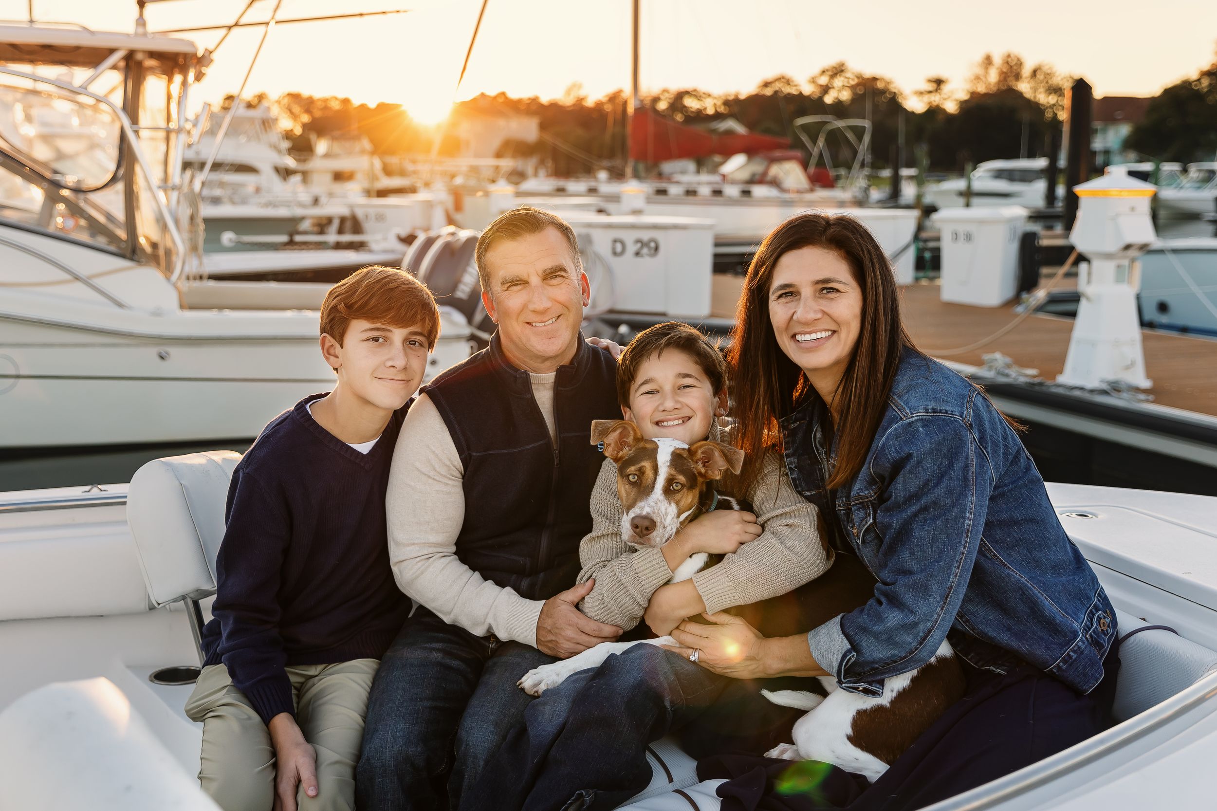 A group of people enjoying a boat ride together on a sunny day at the marina.