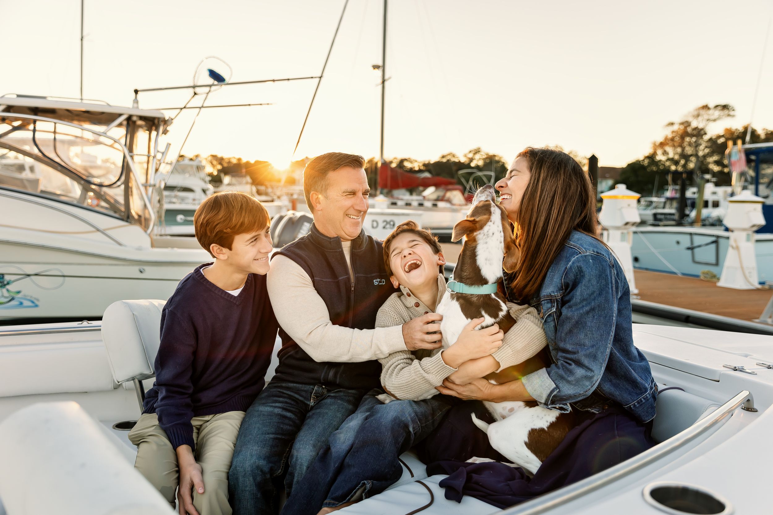 People enjoying a casual moment together on a boat dock during a sunny day.