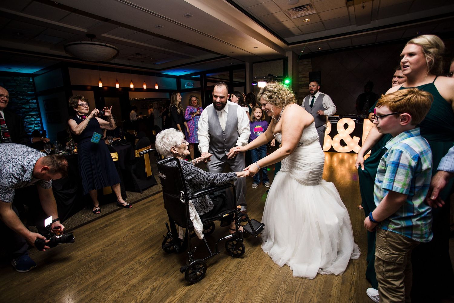 Black and white photo of a celebration with guests clapping in the background.
