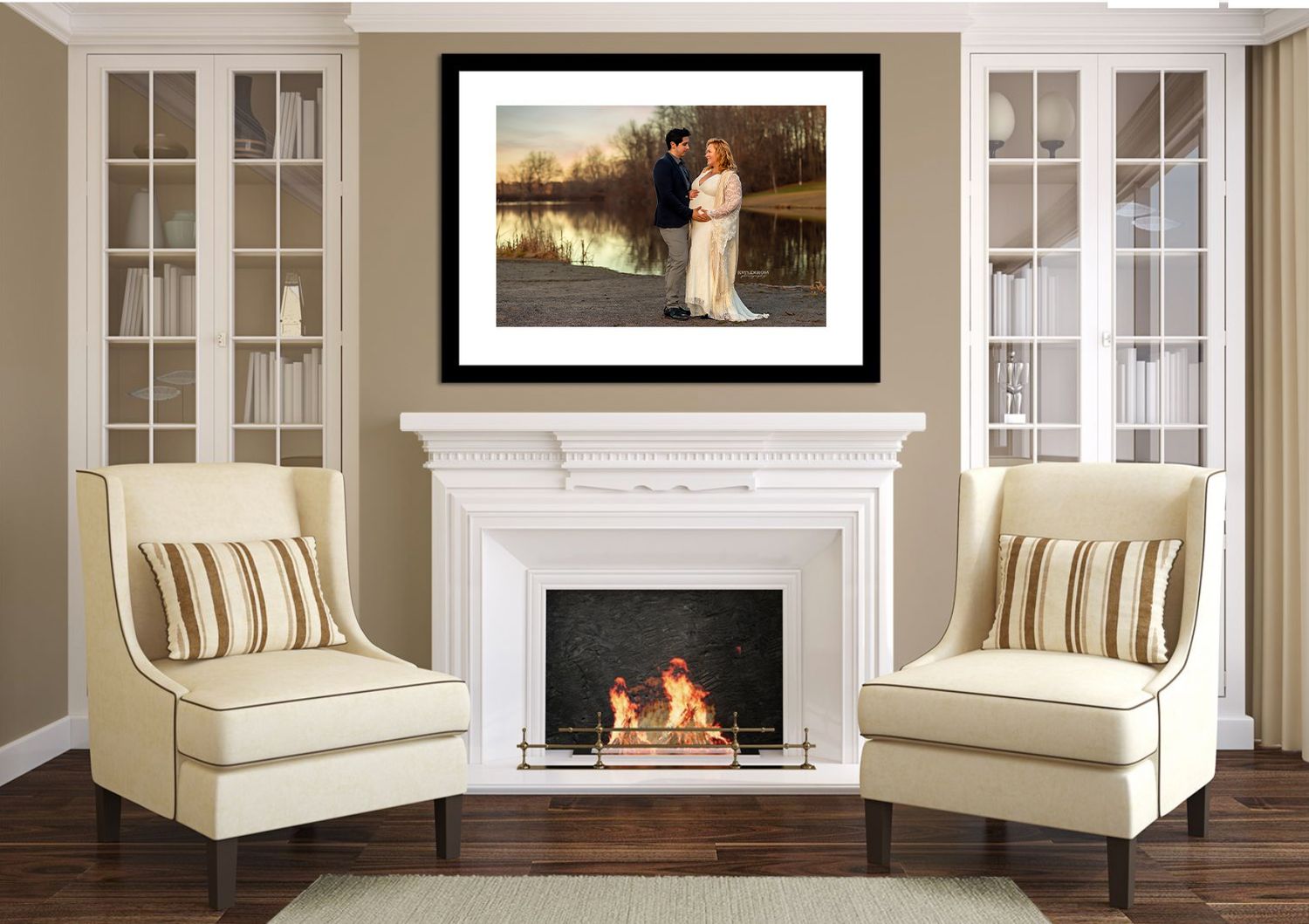 Elegant white fireplace with two cream chairs and framed photograph displayed above in a modern living room interior.