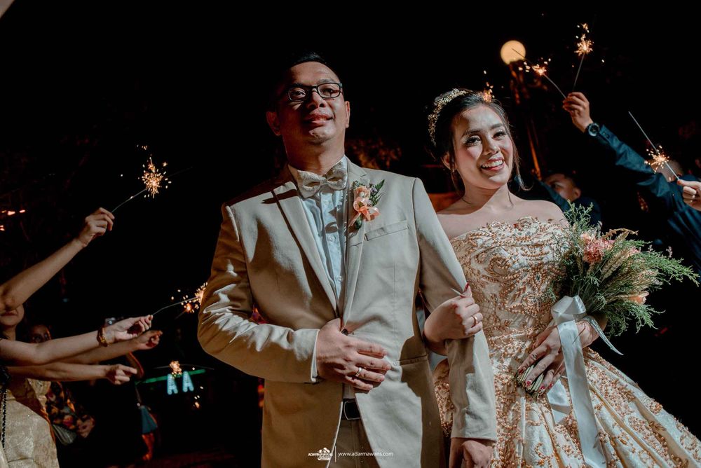 A wedding celebration at night with sparklers creating a festive atmosphere.