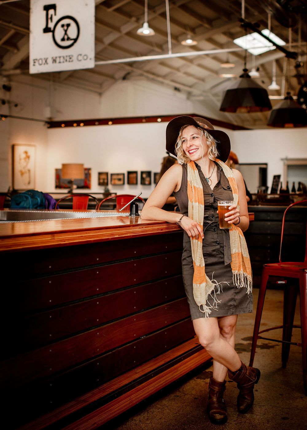 woman standing casually by the bar at topa topa brewery in santa barbara ca