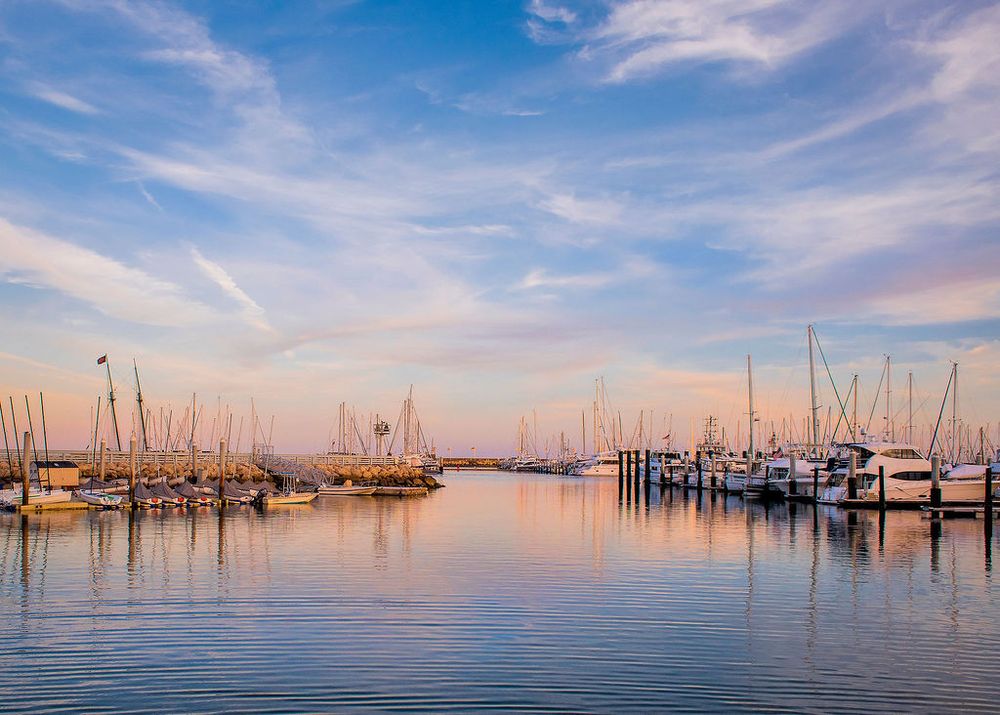 beautiful sunset shot of boats in the santa barbara harbor