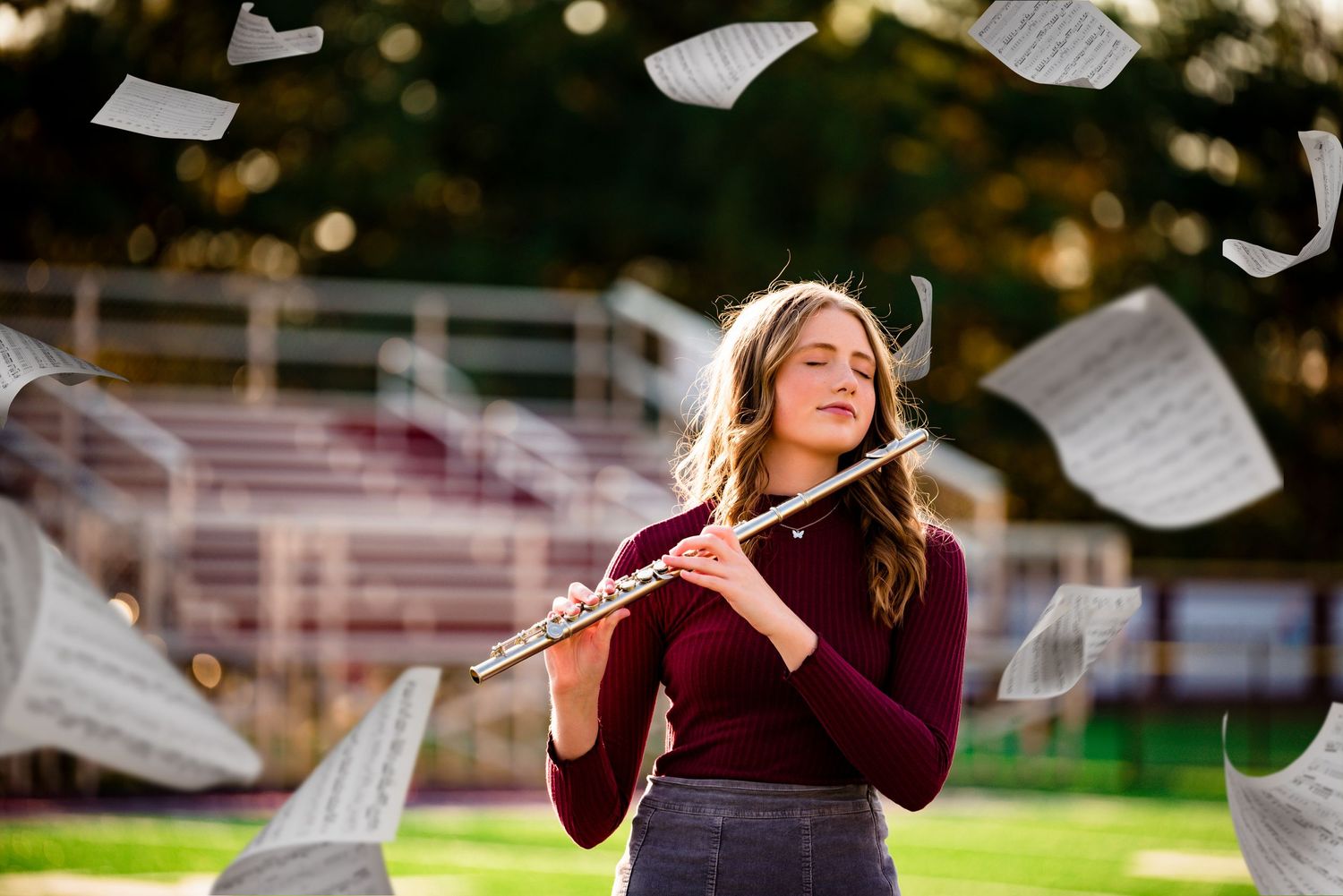 Musician playing flute outdoors with sheet music floating in the air.