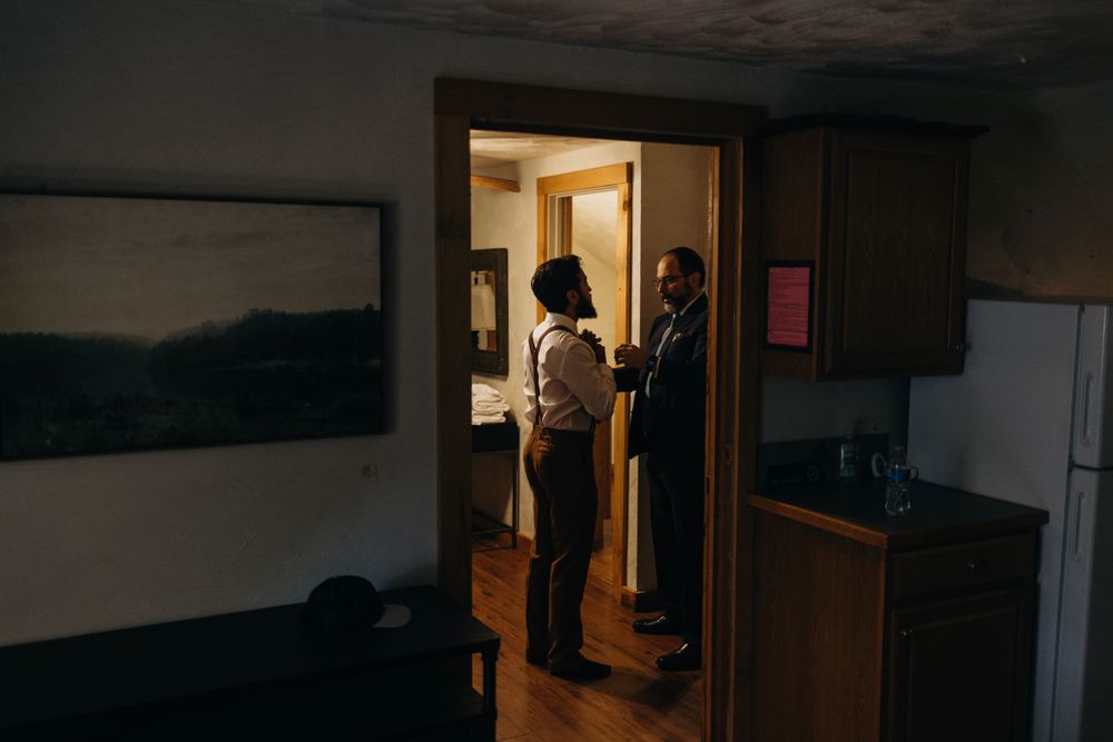 Candid indoor moments captured in a dimly lit hallway with dramatic lighting and shadows.