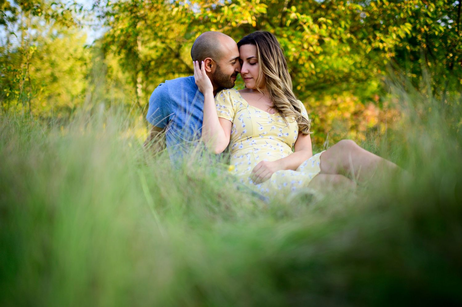 Kitchener Engagement Photography Couple Sitting in Grass Spirits Intrigued Photography