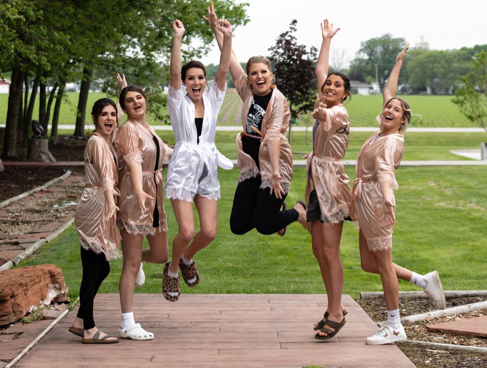 bridesmaids & bride jumping in air