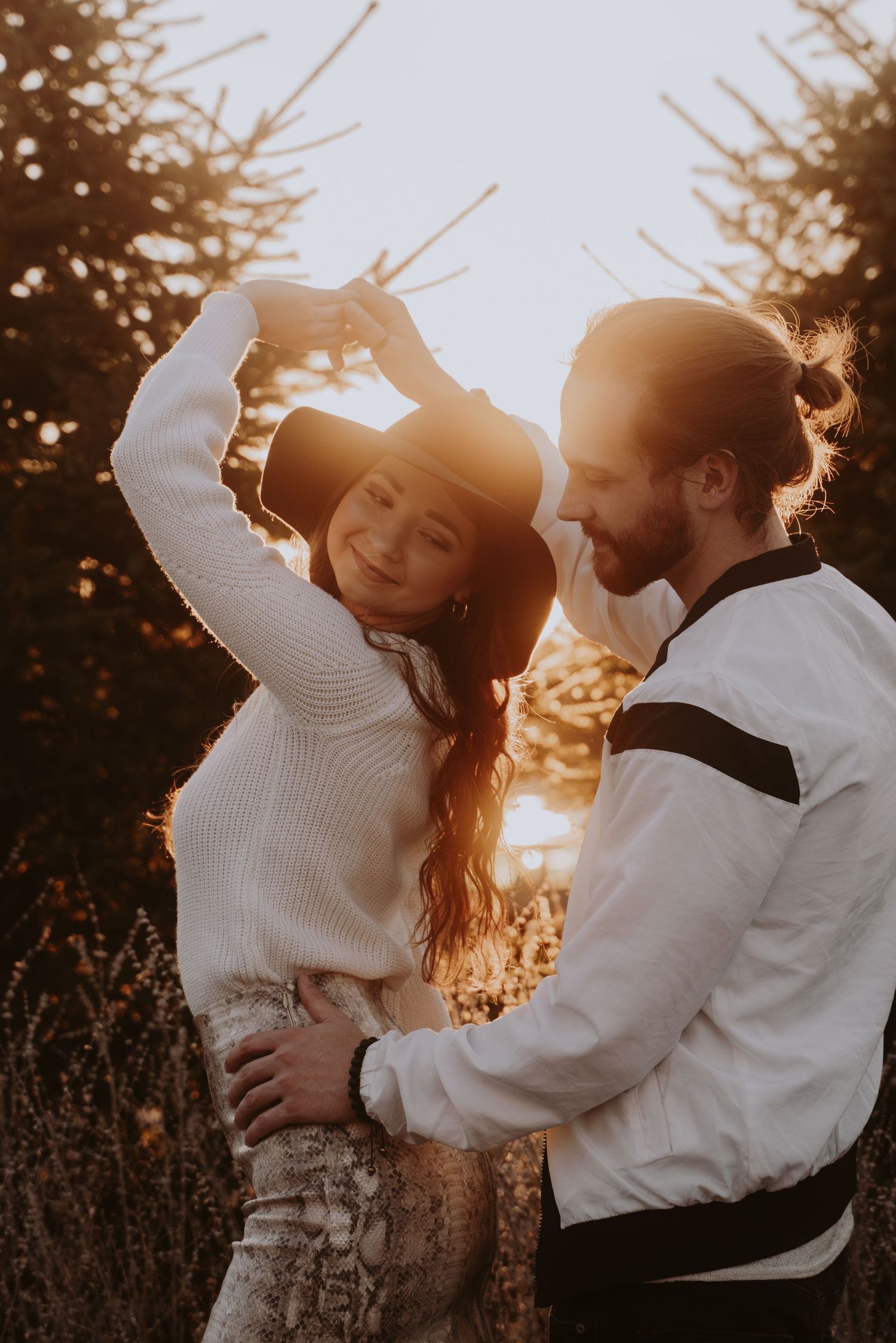 Image of woman and man dancing with sunset glow.