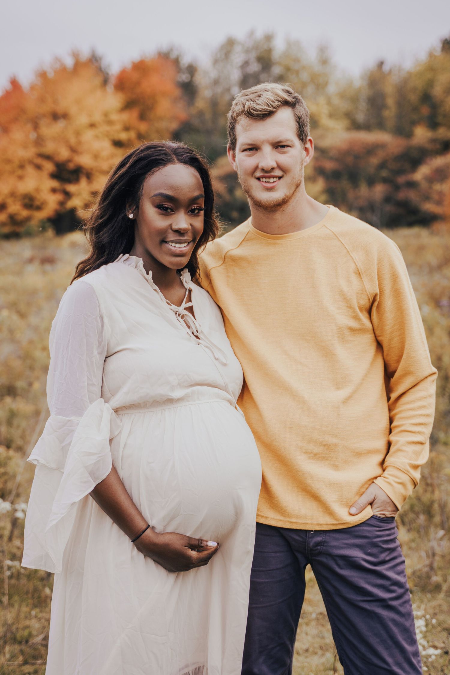 Image of woman and man standing in field.