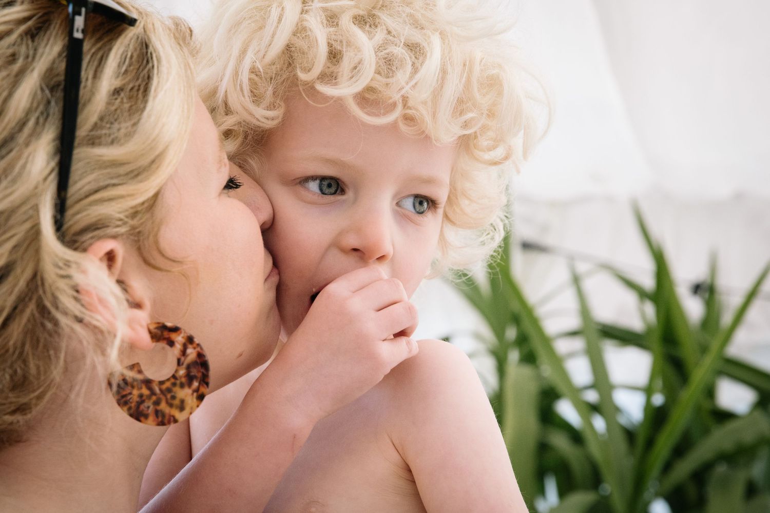 Intimate indoor portrait showing tender moment of connection and affection.