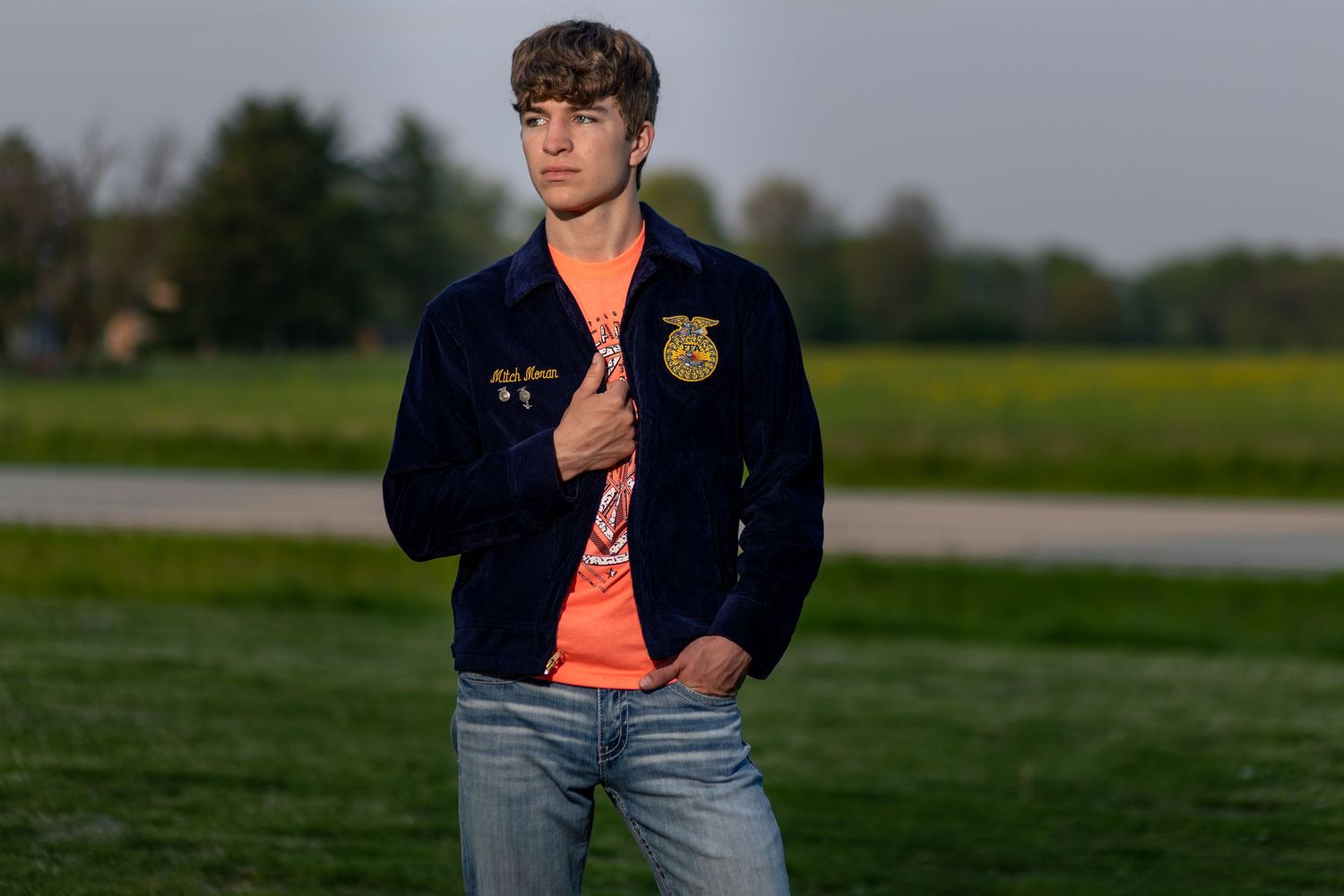 Neoga High School Senior wearing his FFA jacket poses in the Illinois country.