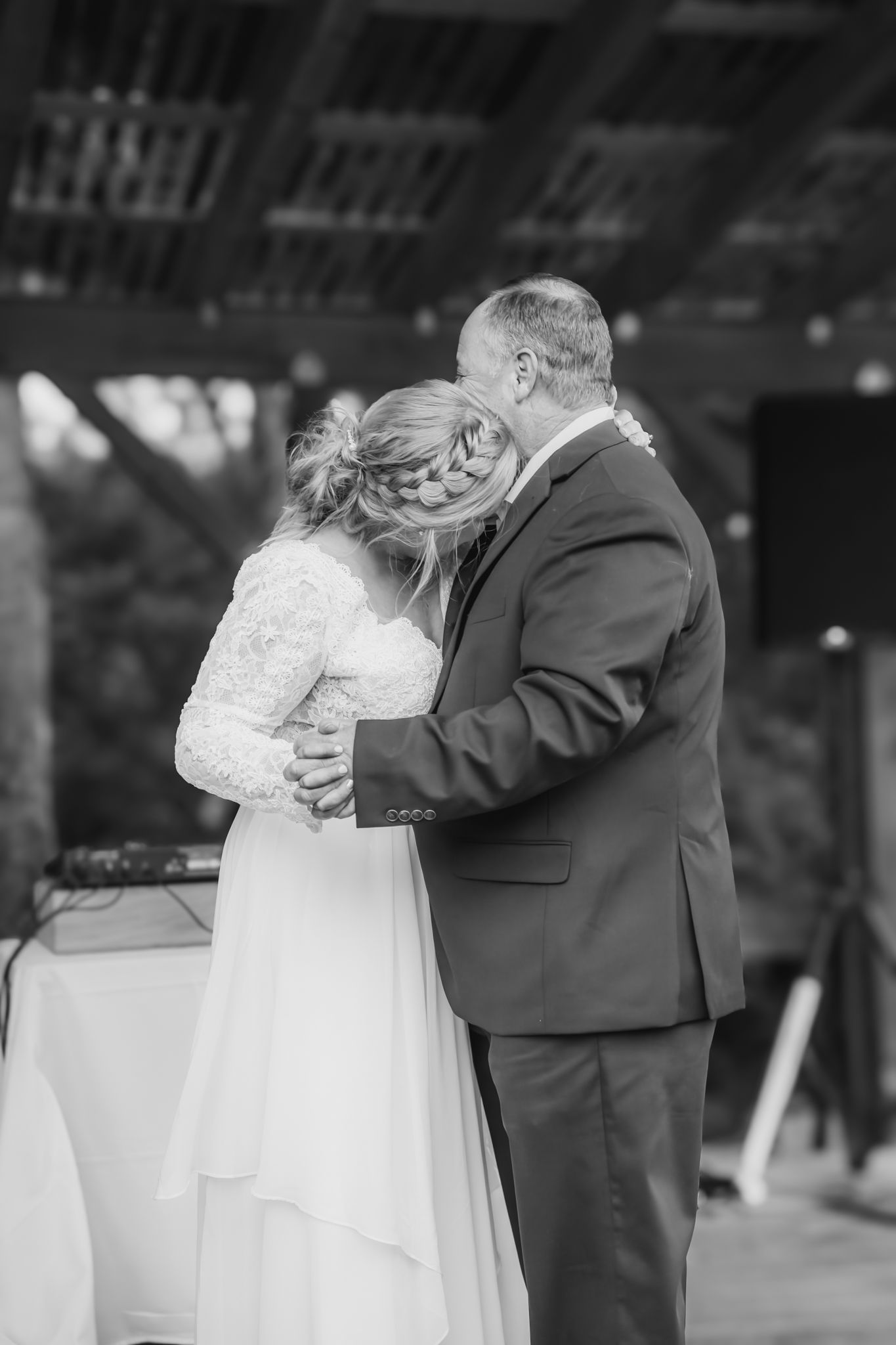 bride hugs her father during the dance