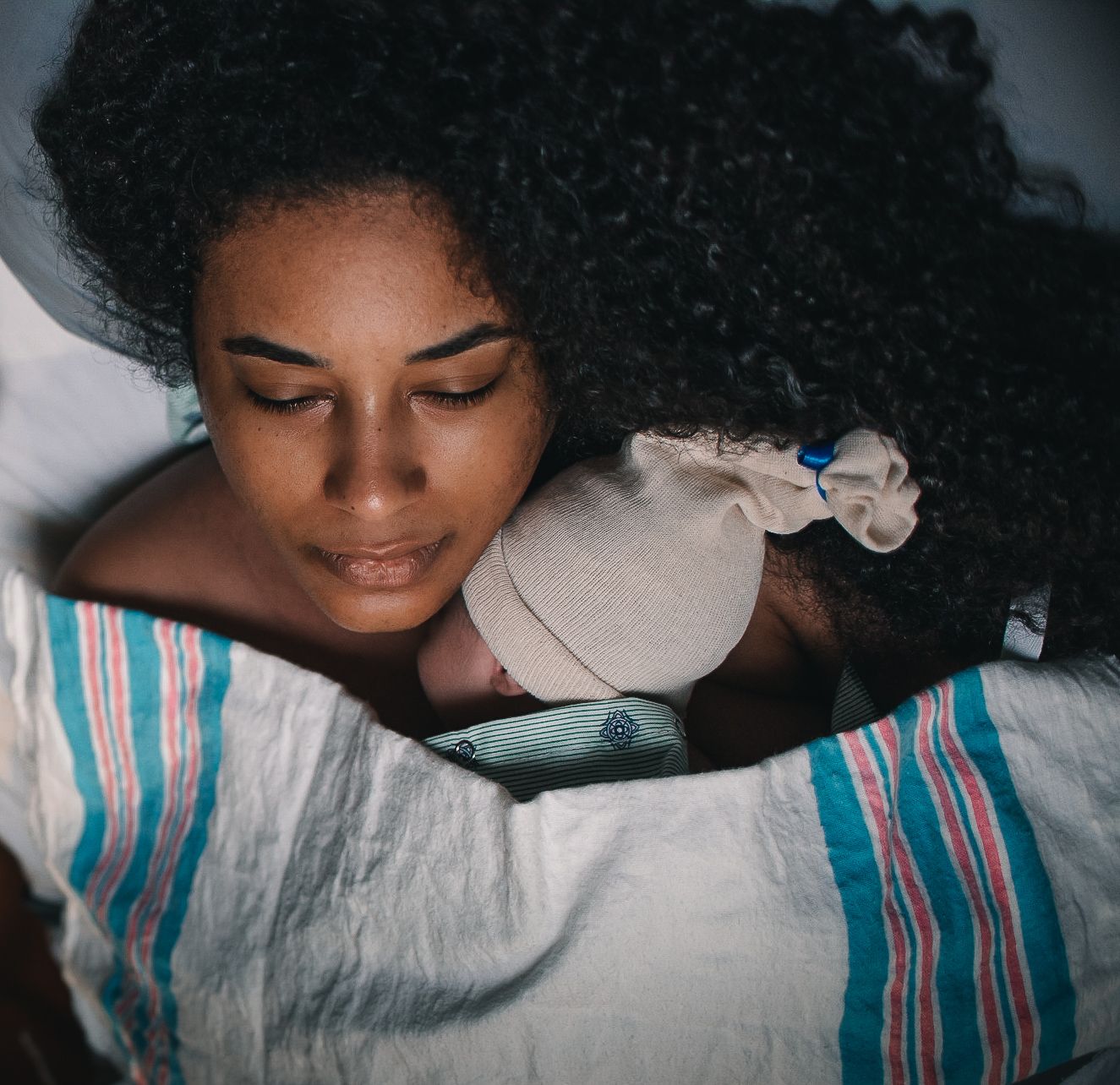 woman holding baby newborn baby skin to skin in hospital
