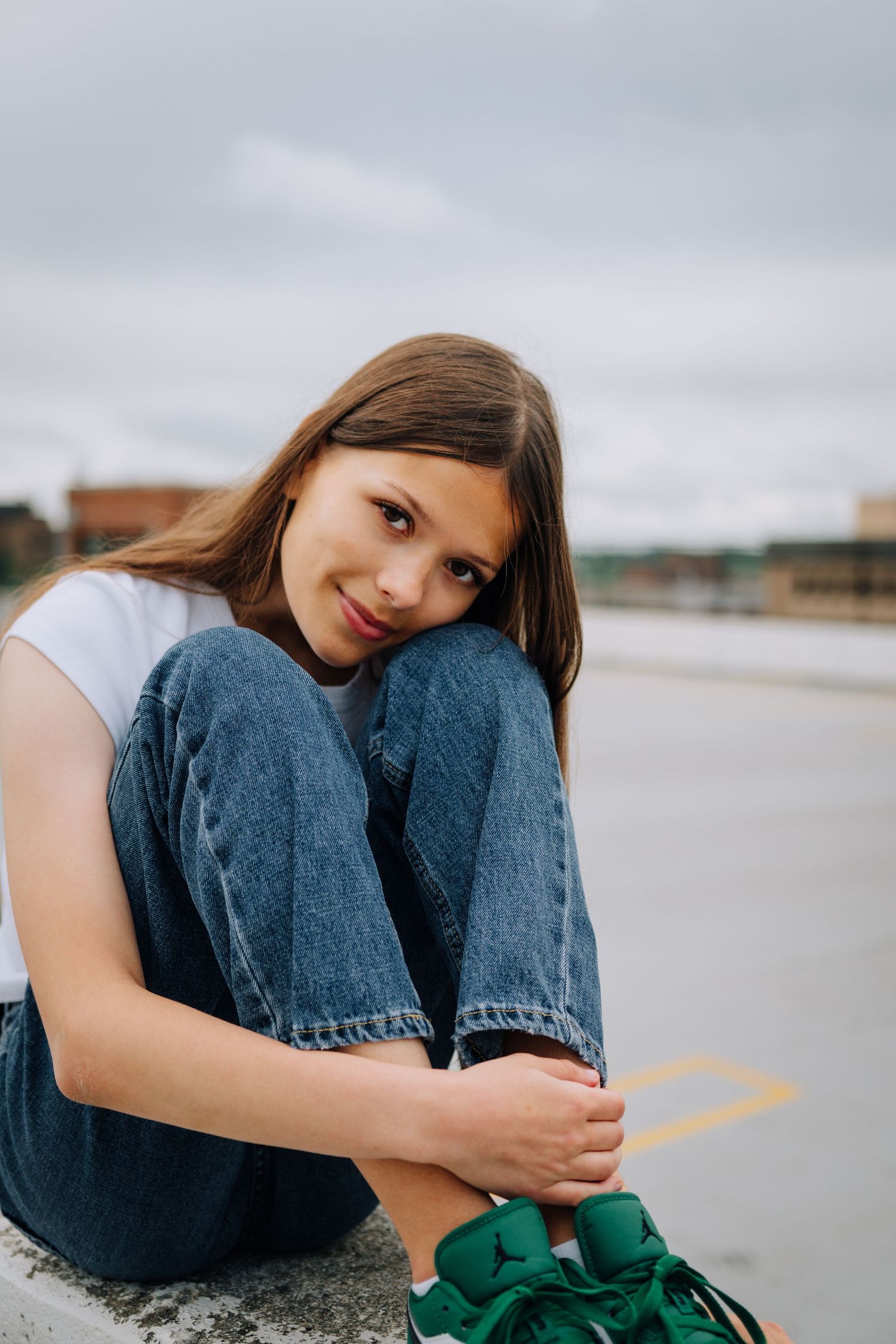Casual portraits by waterfront showing contemplative poses in denim.
