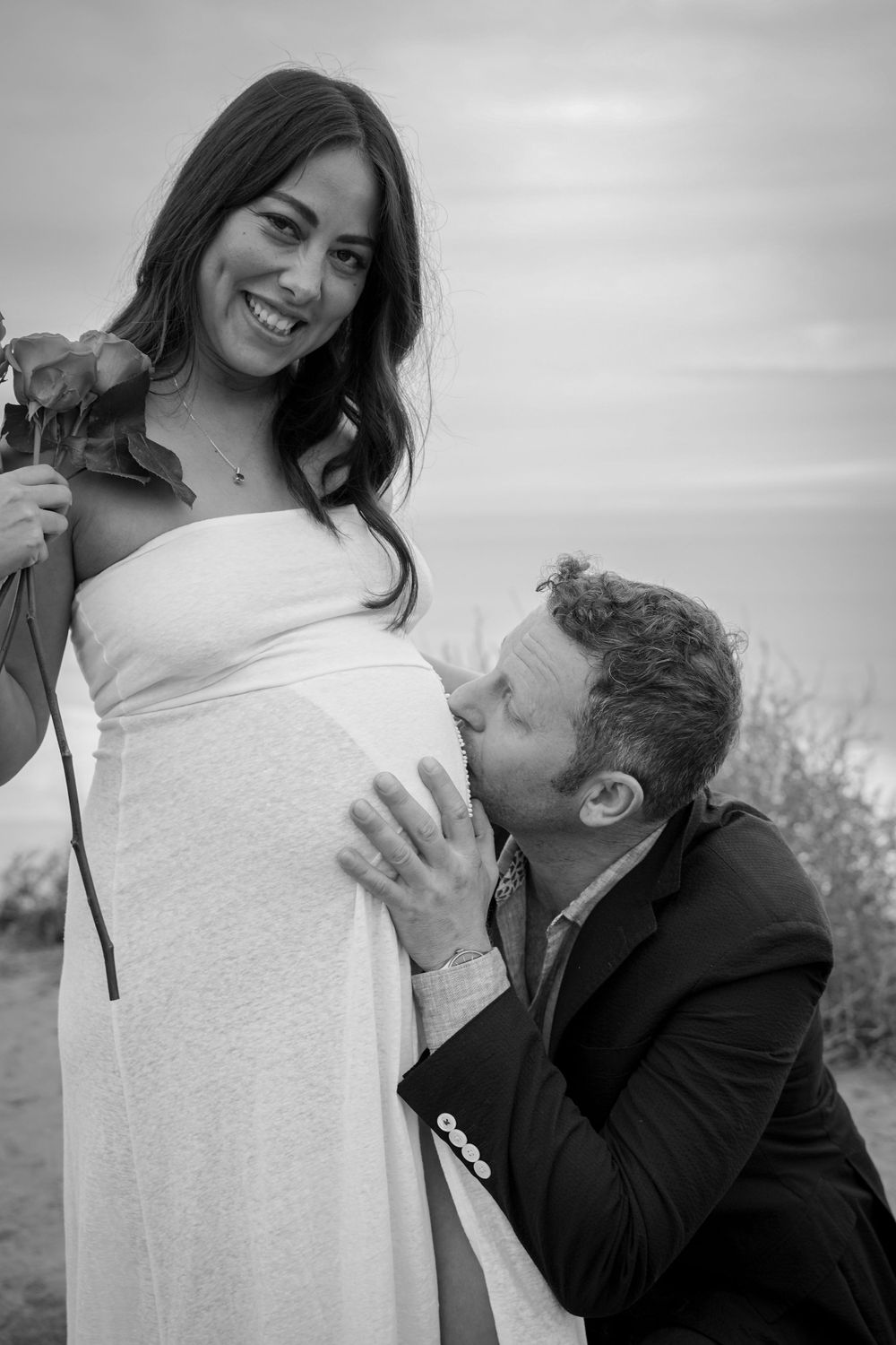 Sweet maternity moment captured in black and white with roses.