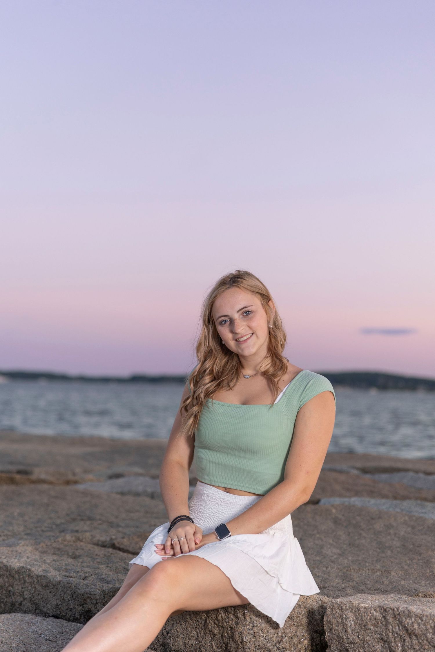 Senior portrait on the breakwater in Rockland Maine
