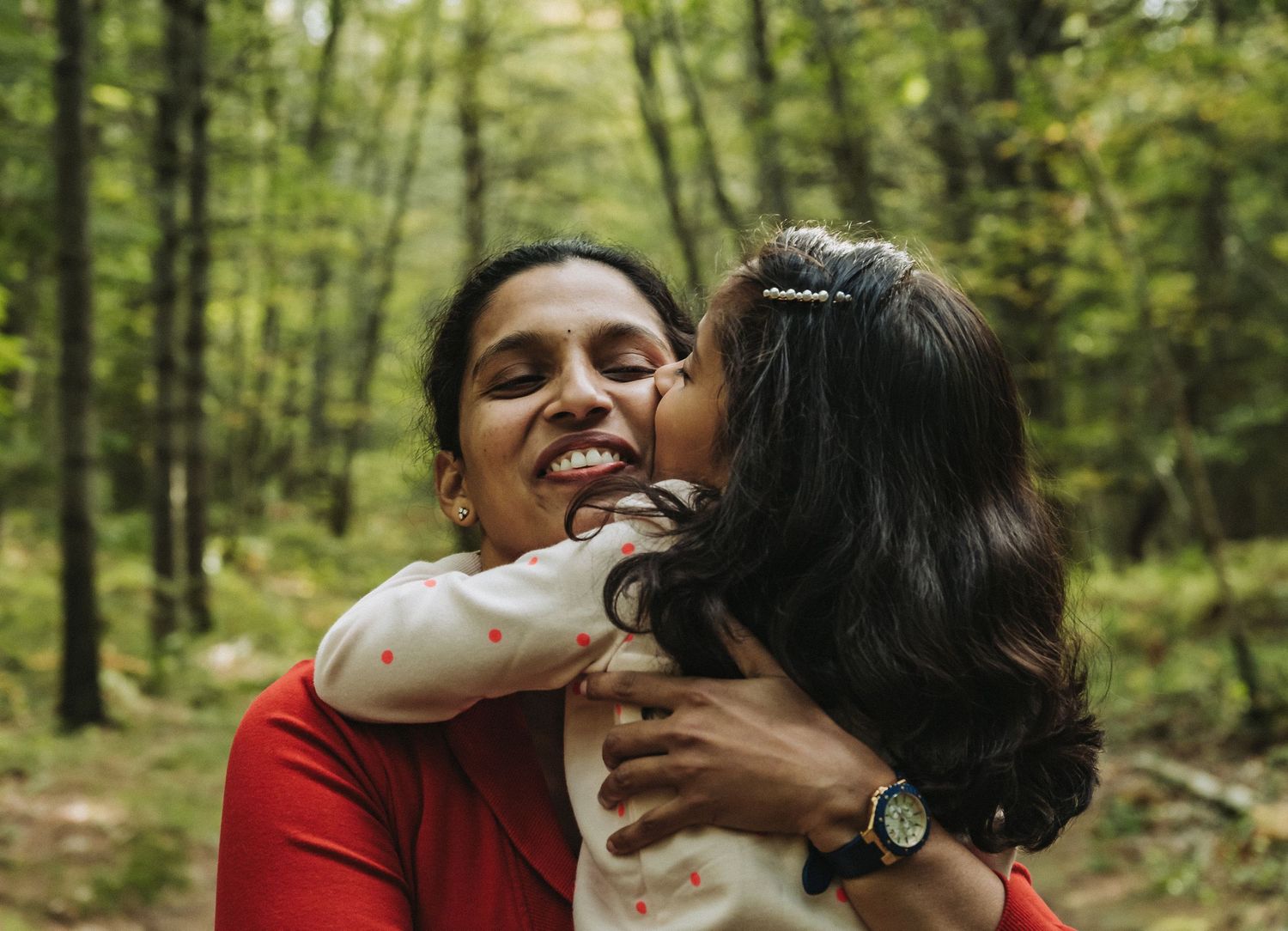 A mother and her daughter smile together during a fall family photo session in Brunswick, Maine.