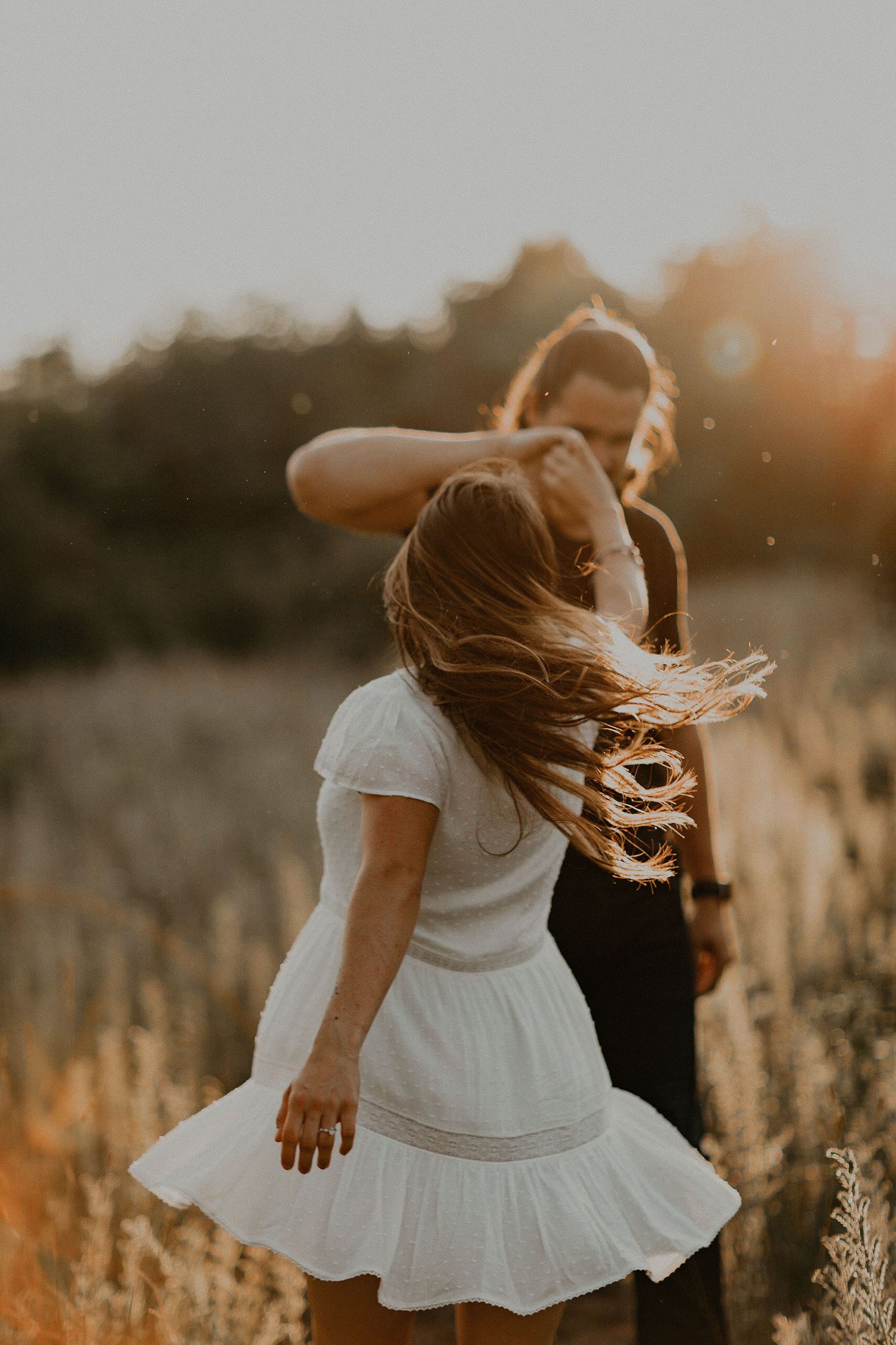 Sunset engagement session, girl twirling