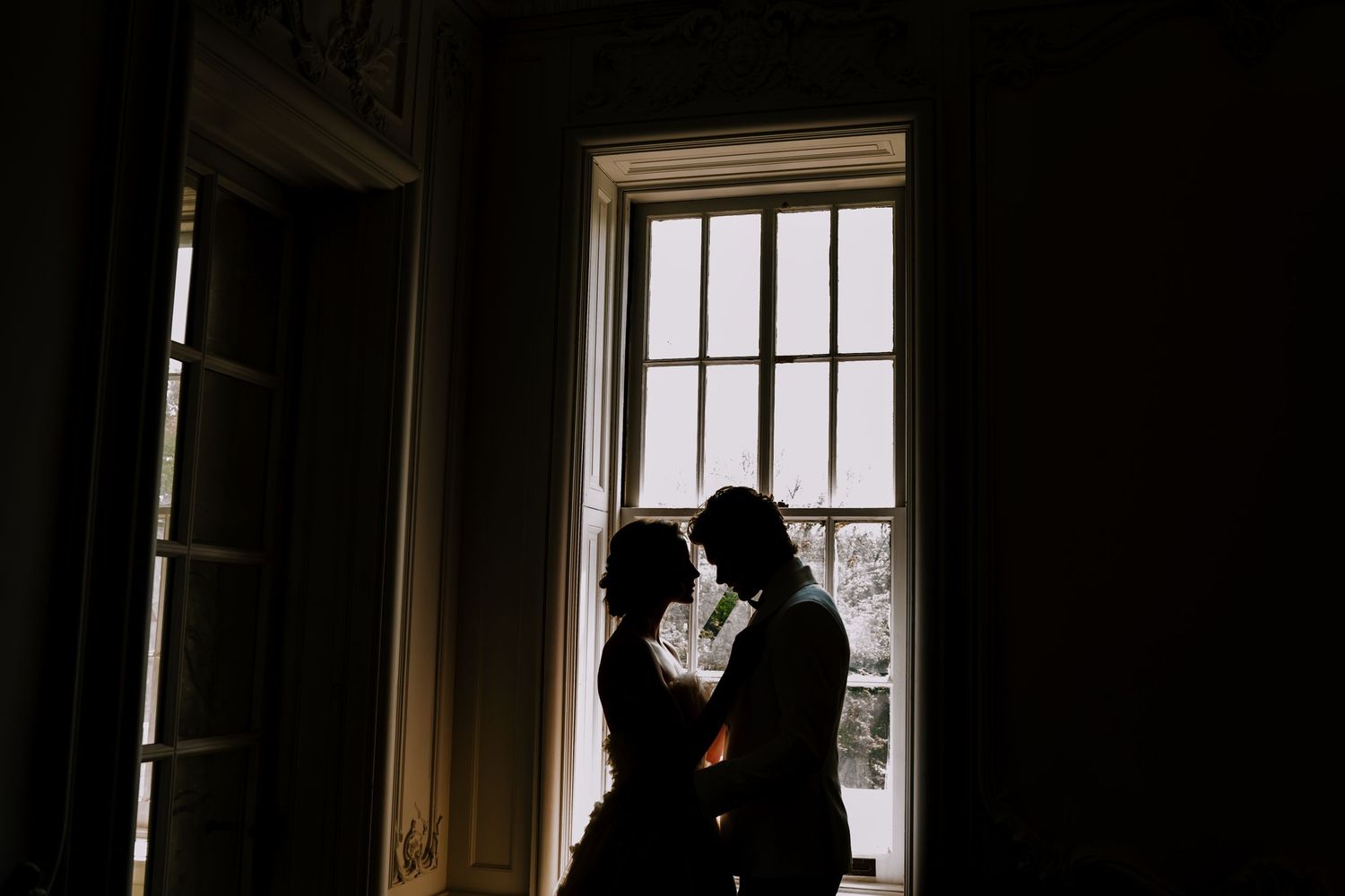 Bride and groom share a private moment inside of an upstairs room, at the Elkins Estate.