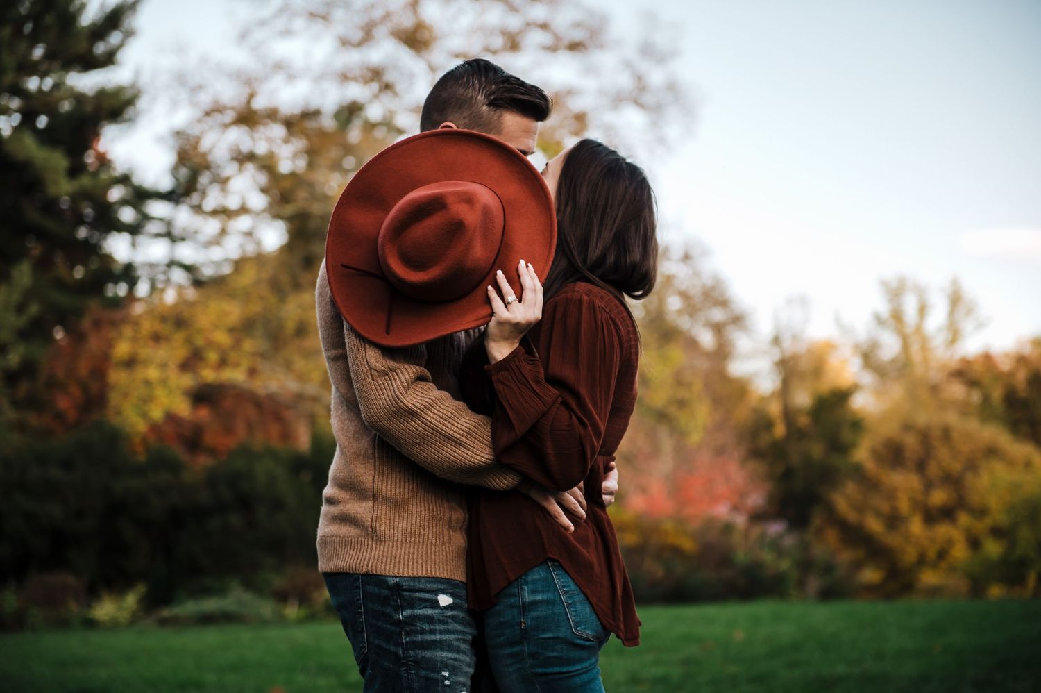 Intimate fall engagement session in a park with autumn colors.