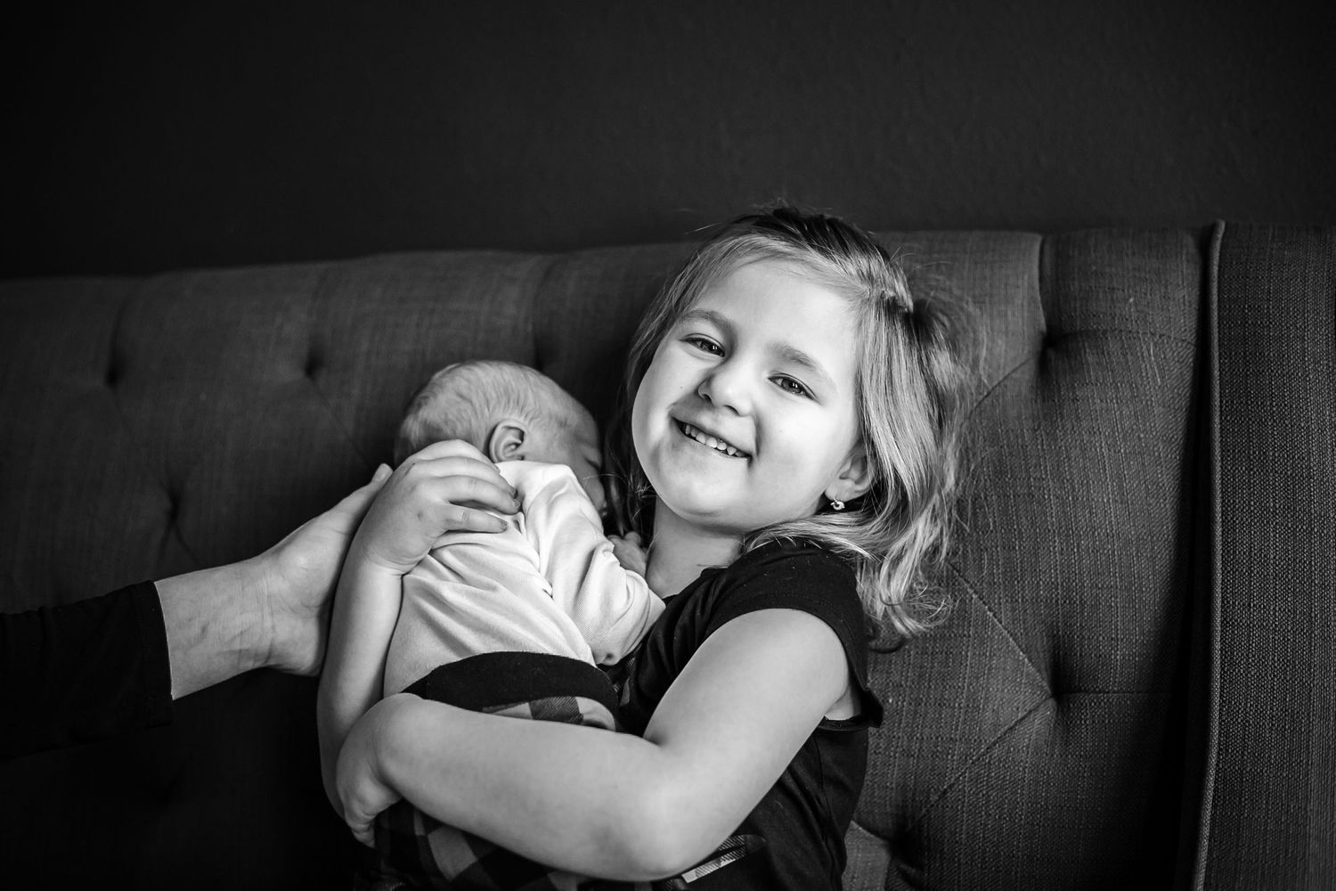 Big sister holding her newborn brother just days after he was born in their home in Hinton, IA.
