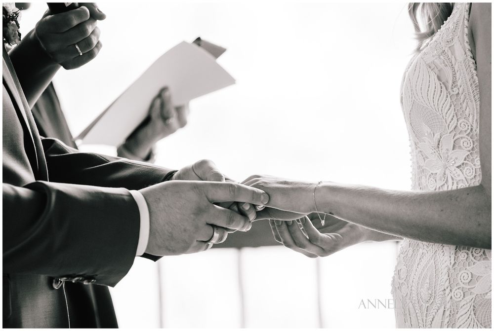 Closeup of bride and groom holdings hands during the ceremony